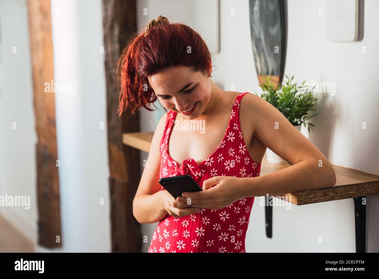 Young Woman using smartphone and smiling Stock Photo