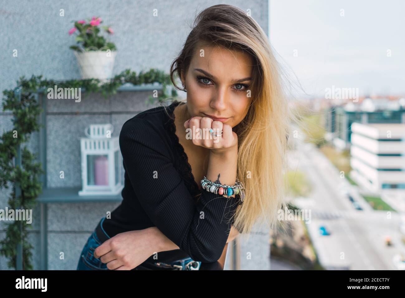 Stylish young Woman on balcony Stock Photo