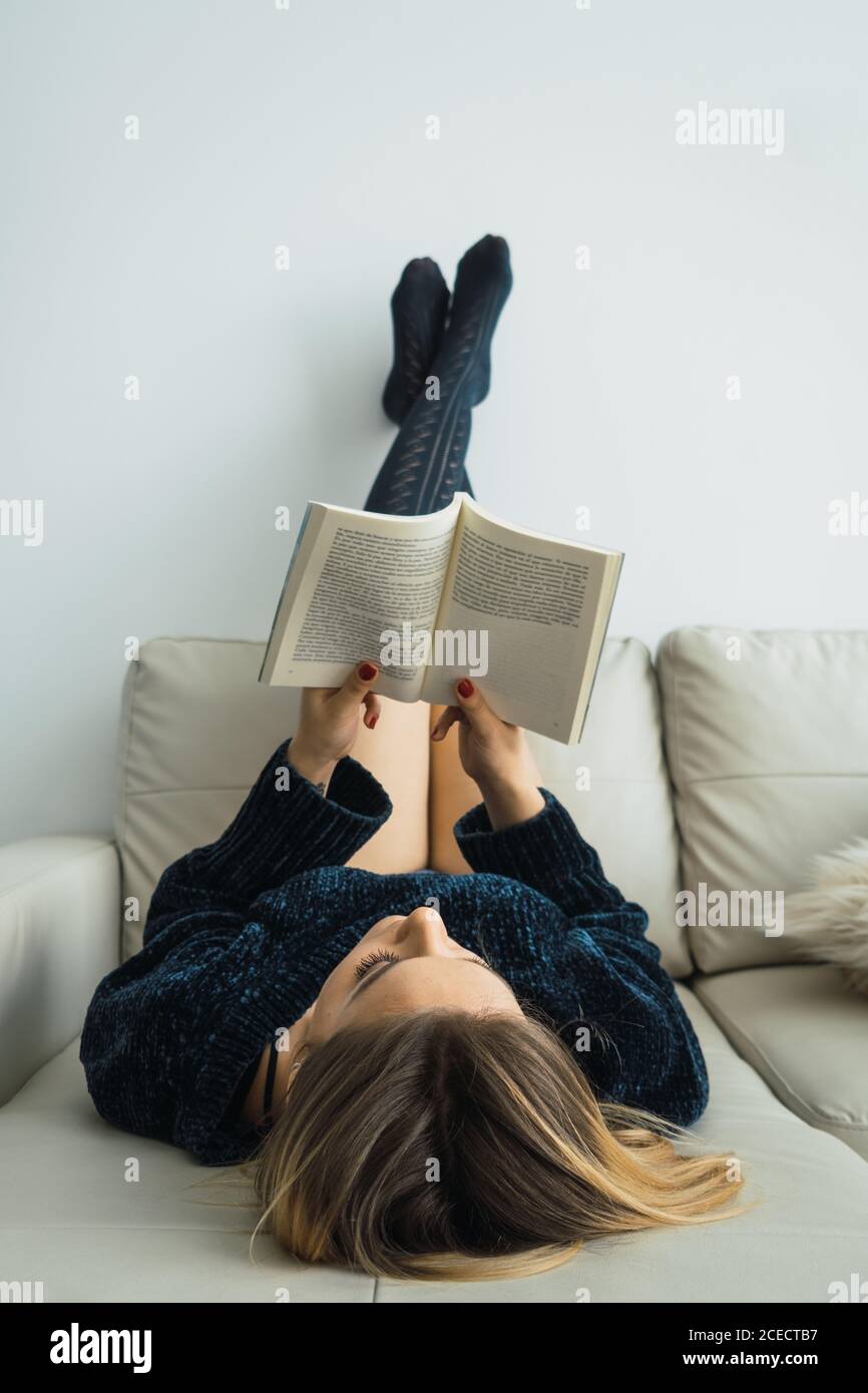 girl absorbed with reading at home Stock Photo