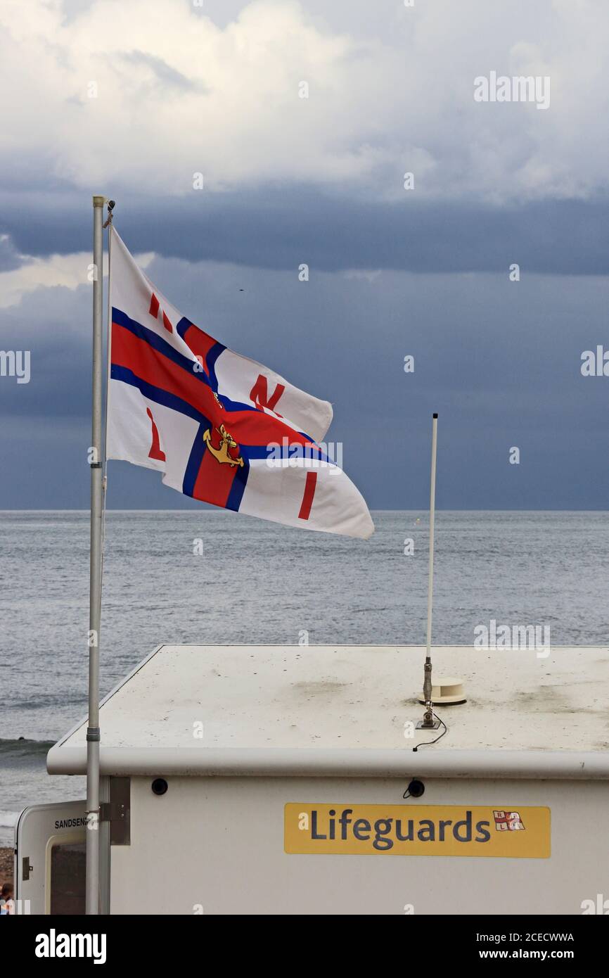 RNLI flag flying over Lifeguard Station, Sandsend, Whitby Stock Photo
