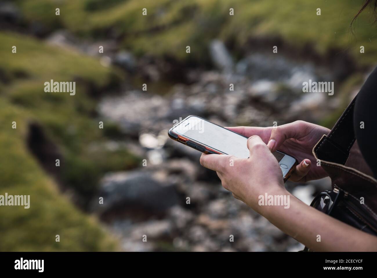 Woman using smartphone in nature Stock Photo