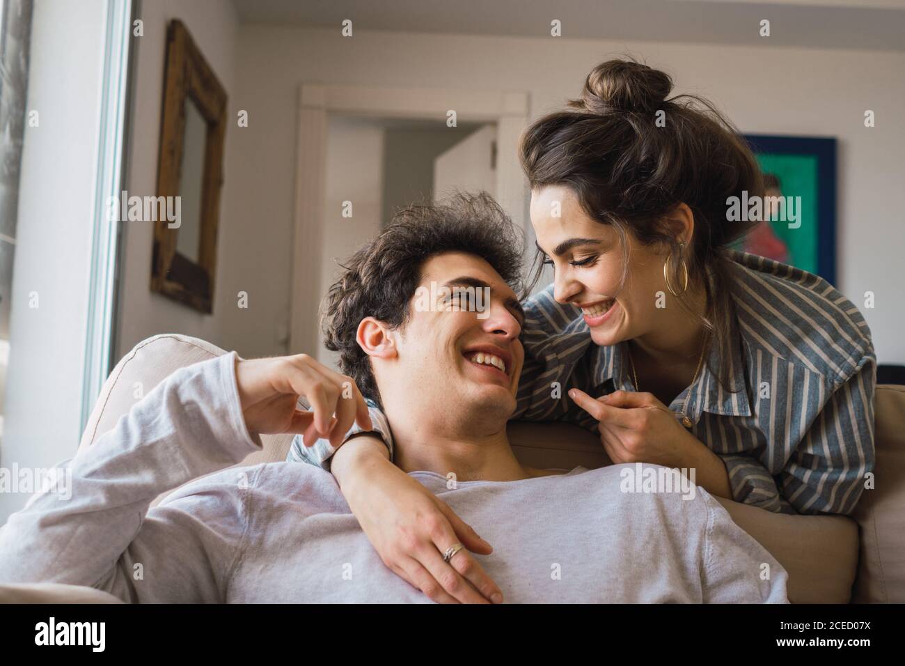 Cheerful couple having fun at couch Stock Photo