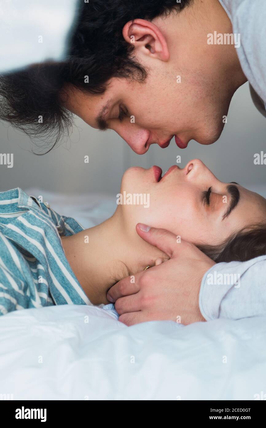 Tender couple lying on bed Stock Photo