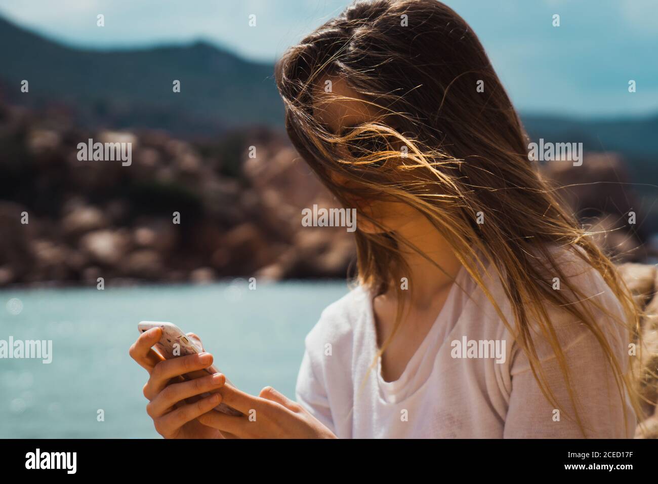 Woman taking selfie with smartphone at seaside Stock Photo