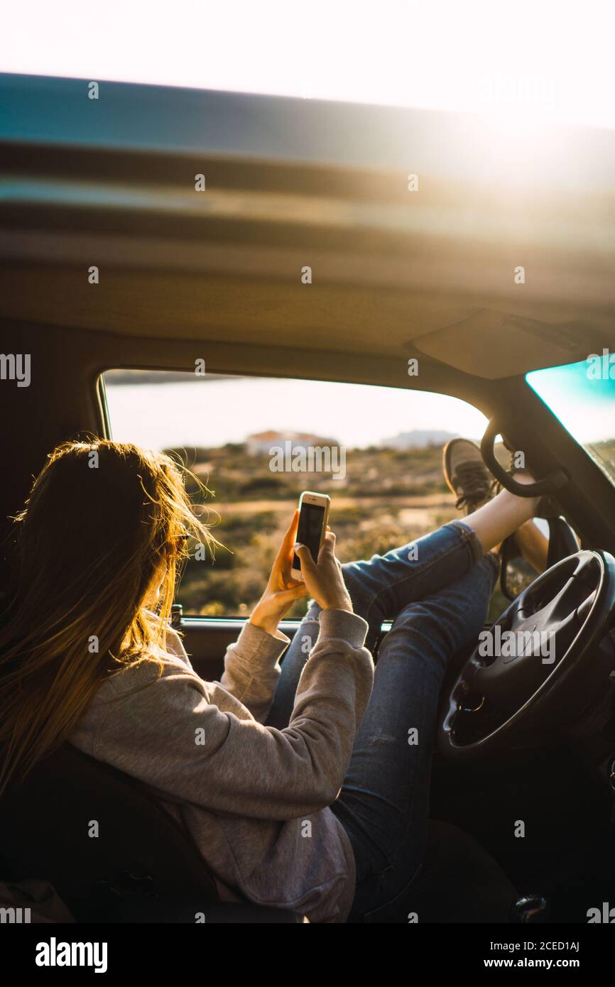Female tourist using smartphone driving hi-res stock photography and ...