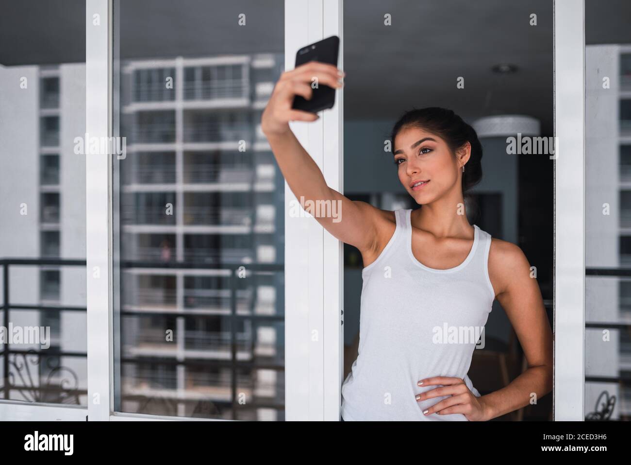 Woman taking selfie on balcony hi-res stock photography and images - Alamy
