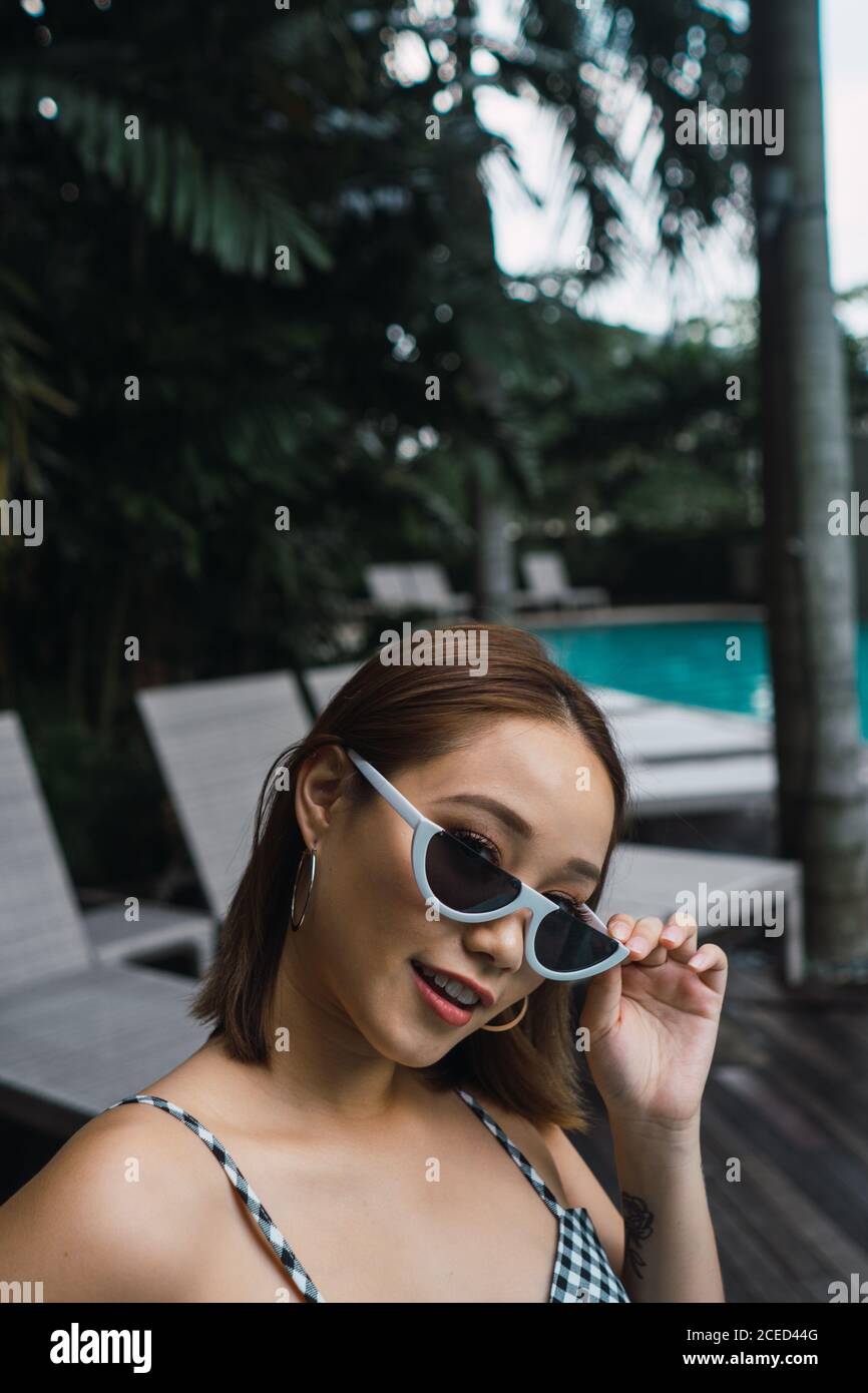 Pretty Woman in sunglasses at pool Stock Photo - Alamy