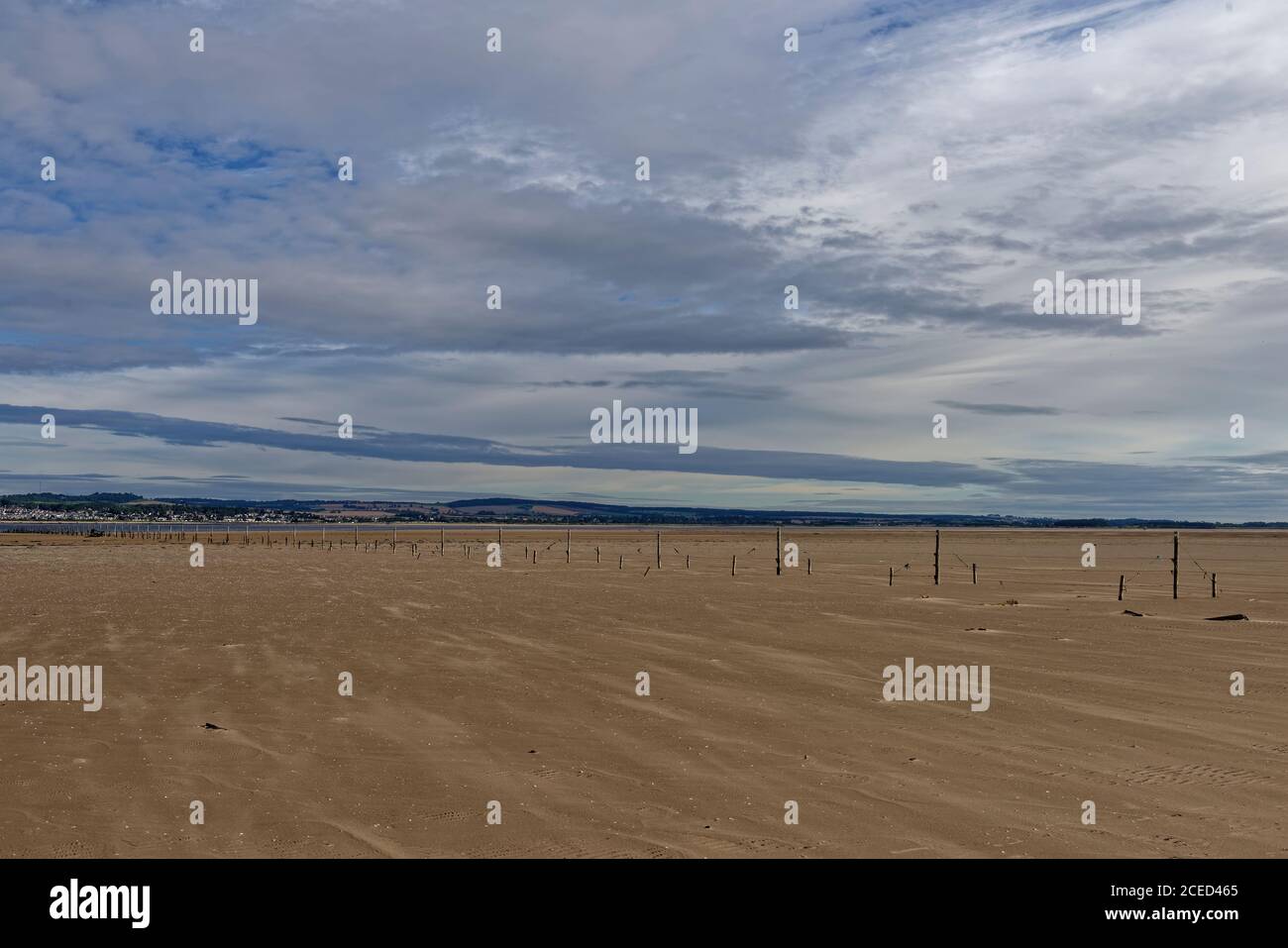 The tensioned Wood and wire fishing Fence line stretching across the Tay Estuary, close to Tentsmuir Point on a sunny morning in August. Stock Photo