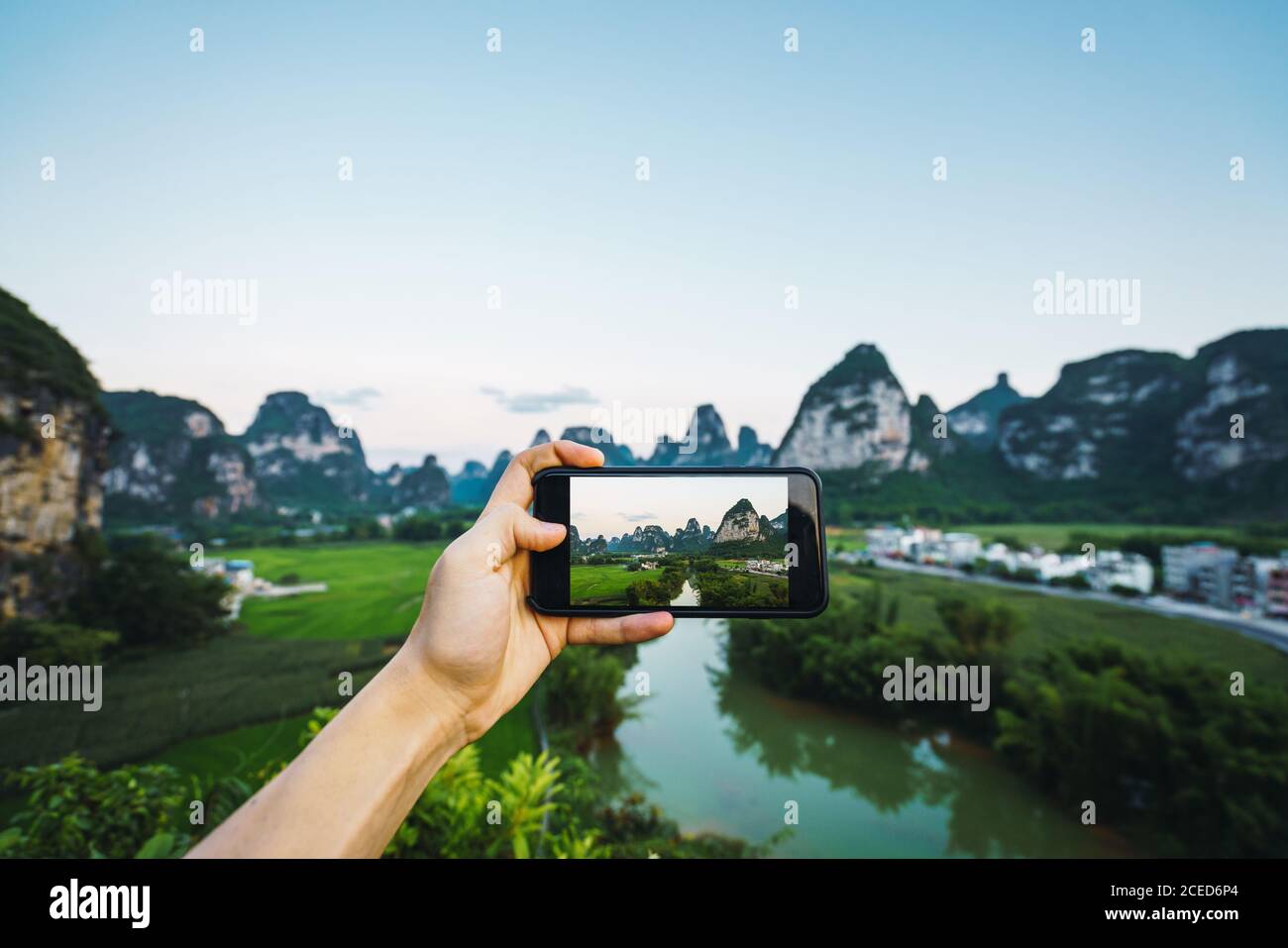 Hand taking photo of Guangxi province landscape Stock Photo