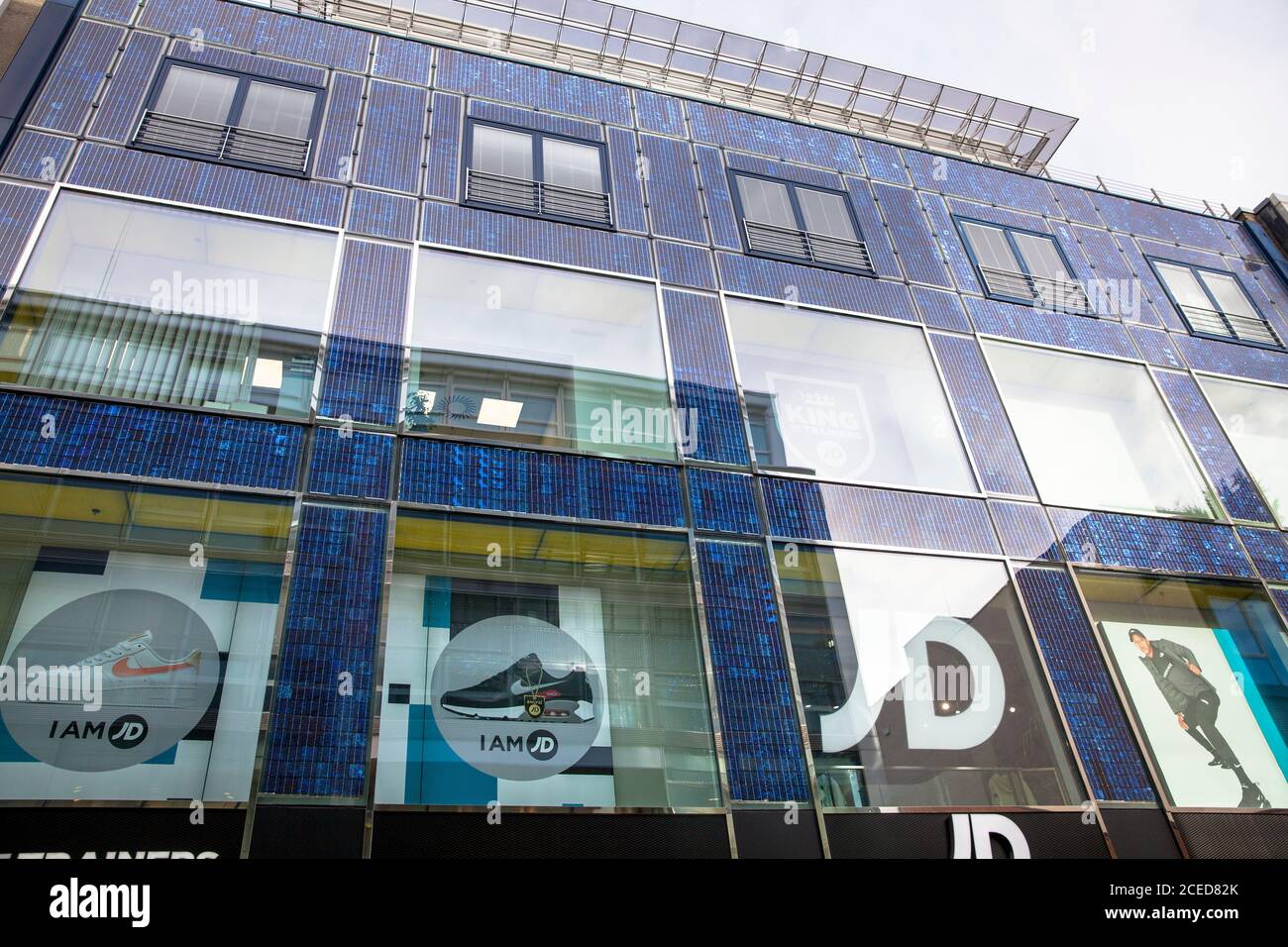 JD Sports Fashion store at the shopping street Hohe Strasse, photovoltaic plant on the facade, Cologne, Germany.  JD Sports Fashion store in der Fussg Stock Photo