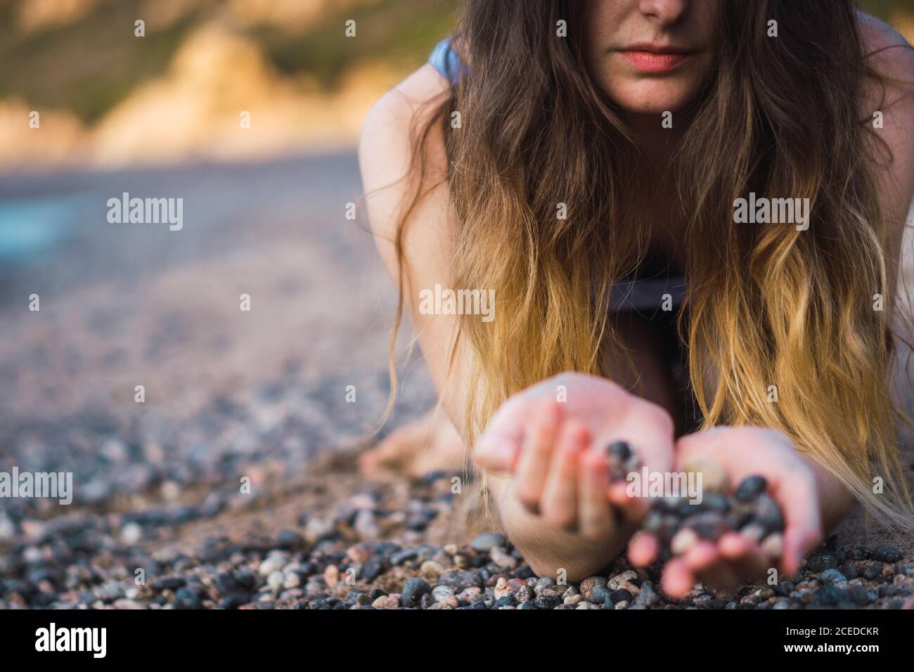 Crop person with handful of pebble Stock Photo