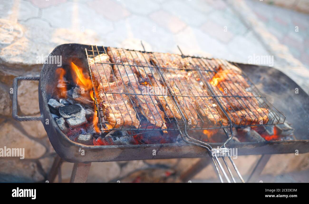meat is grilled on a charcoal grill Stock Photo - Alamy