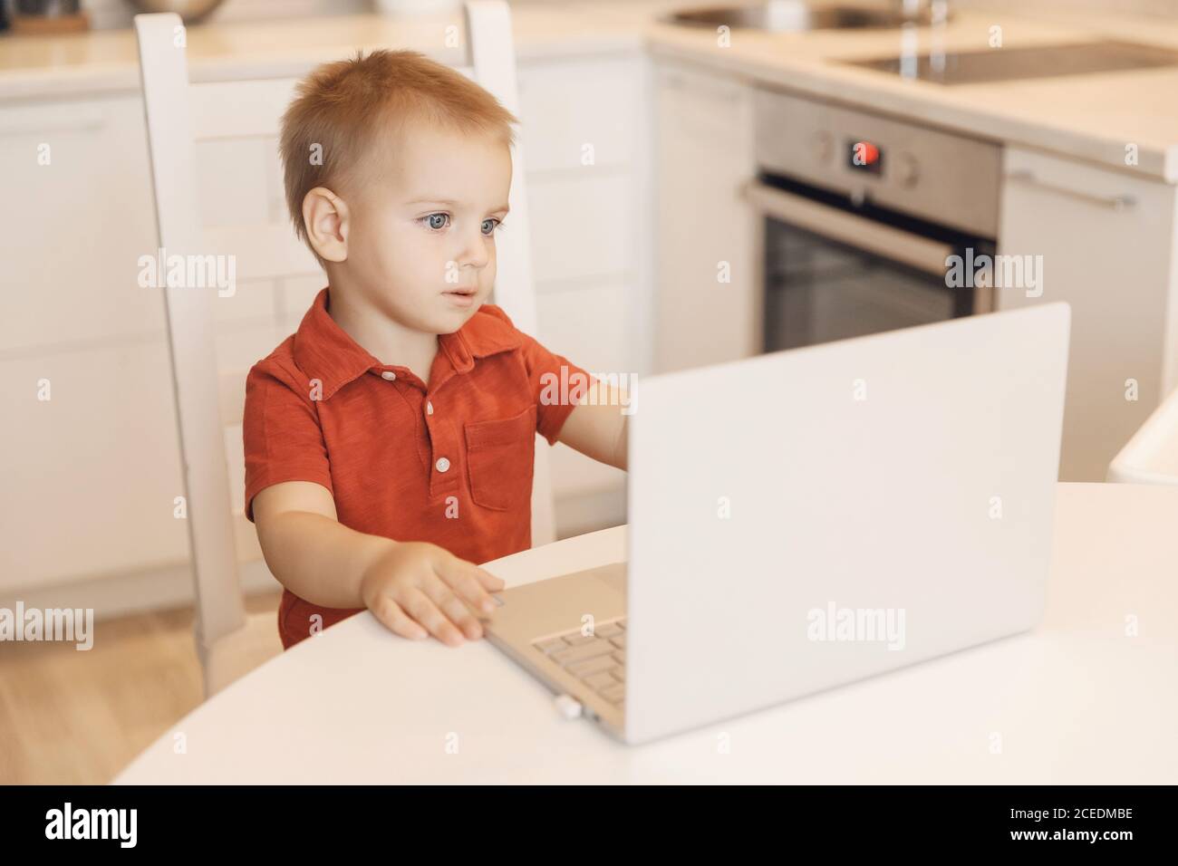 Online education of children quarantine, boy learns through video chat. Concept viewing cartoons or videoblog Stock Photo