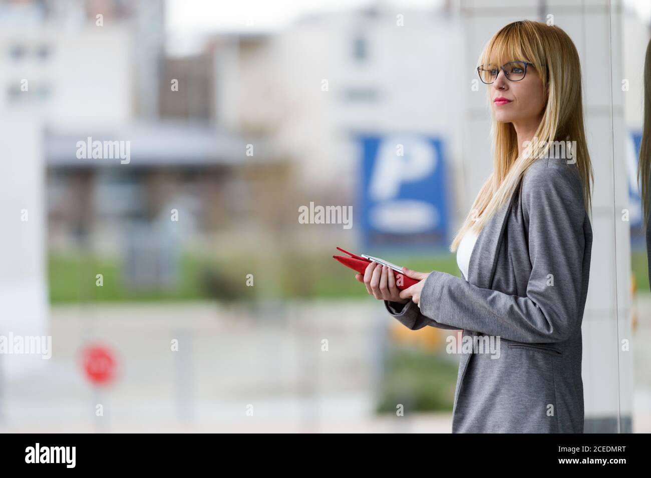 Young attractive Woman standing with tablet Stock Photo