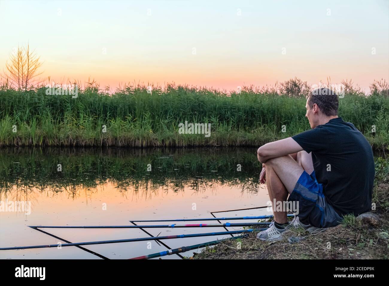 Sunrise or sunset fishing. Fishing rods on the background of the lake. Sports  fishing. The bell hangs on a fishing line. selective focus Stock Photo -  Alamy