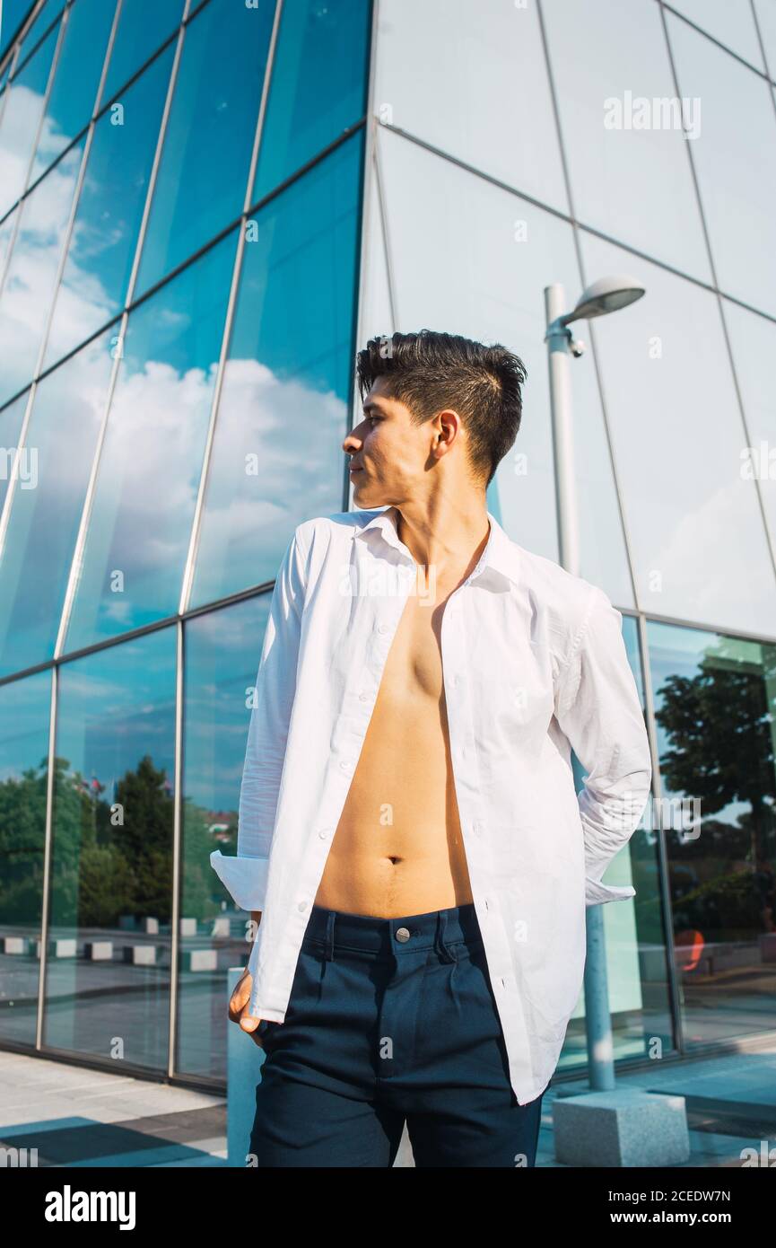 Handsome man in white shirt against skyscraper Stock Photo