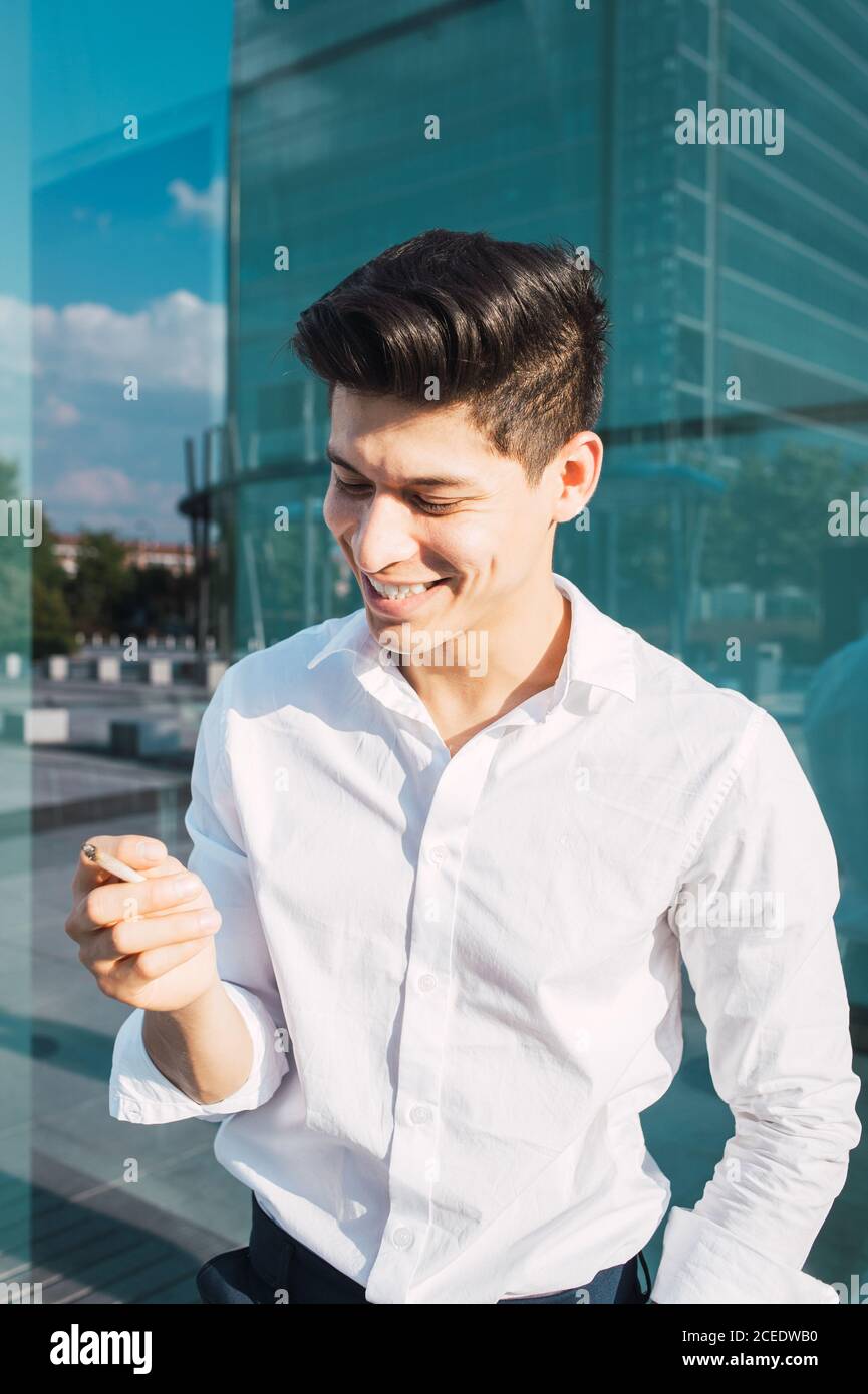 Handsome young man smoking cigarette Stock Photo