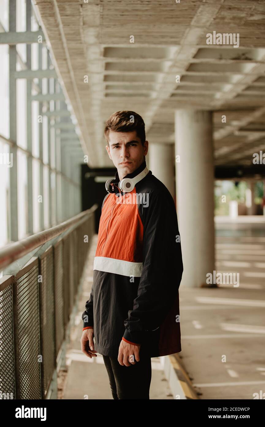 Young thoughtful man standing inside building Stock Photo