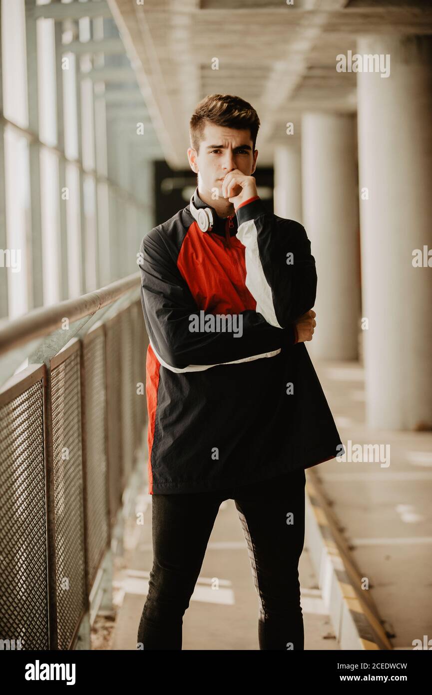 Young thoughtful man standing inside building Stock Photo