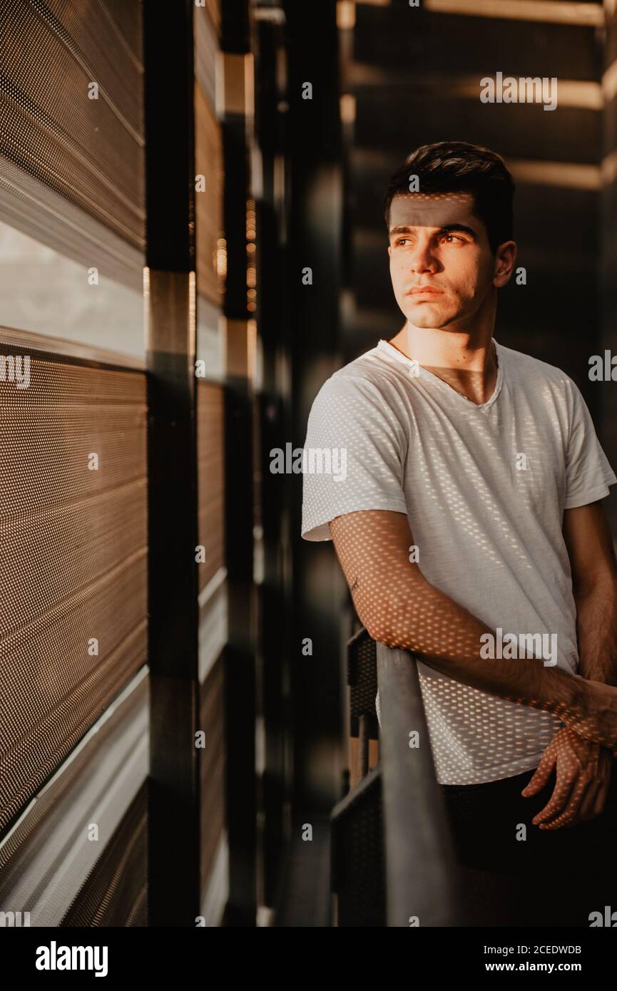 Young thoughtful man standing inside building Stock Photo