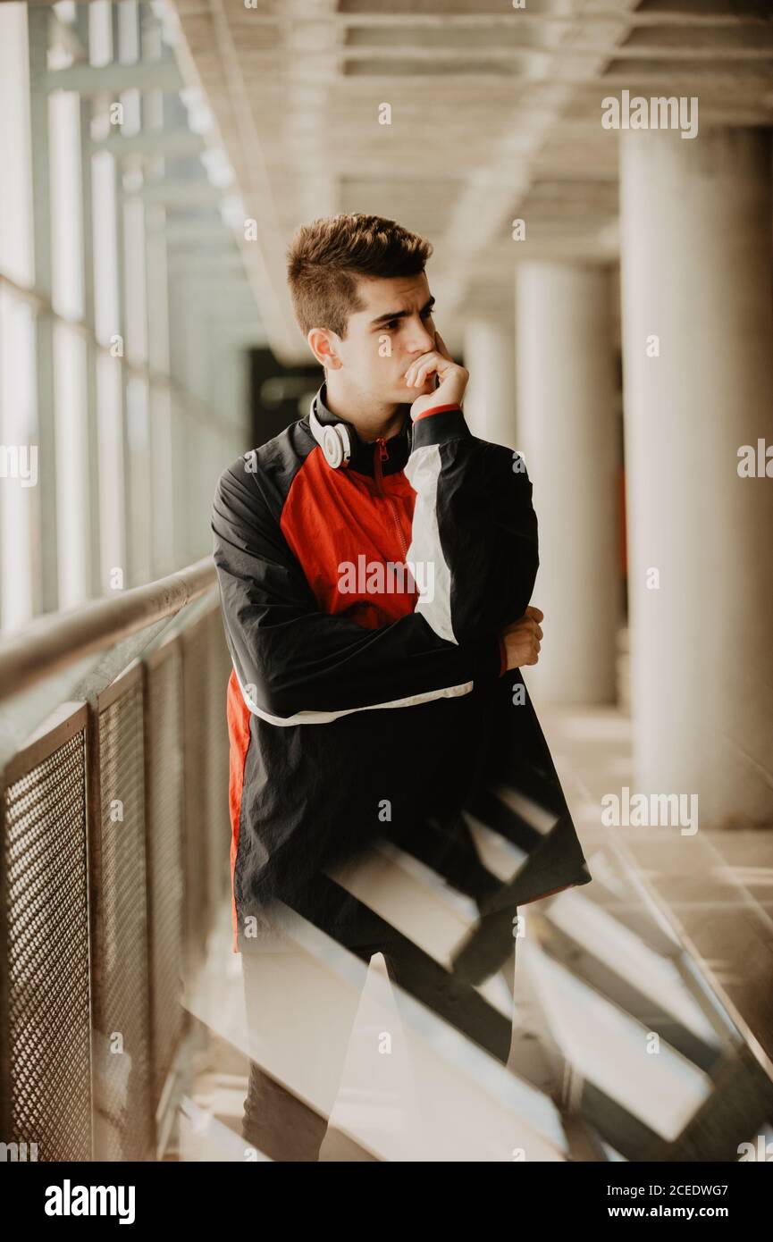 Young thoughtful man standing inside building Stock Photo