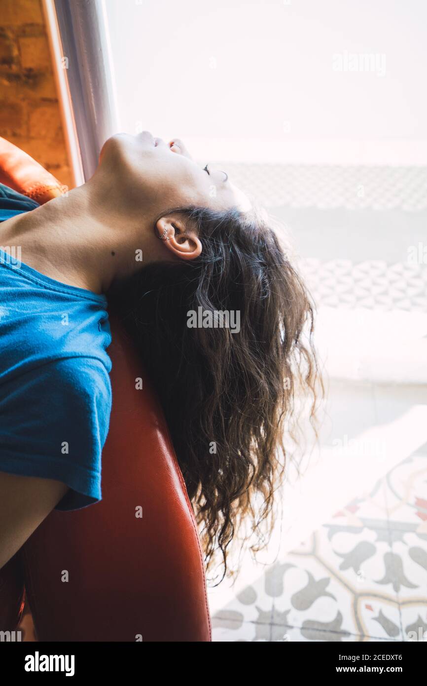 Young Woman relaxing on sofa with closed eyes Stock Photo - Alamy