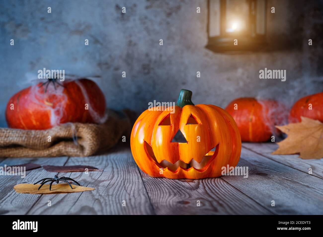 Halloween holiday background with jack o'lantern, pumpkins, spider web ...