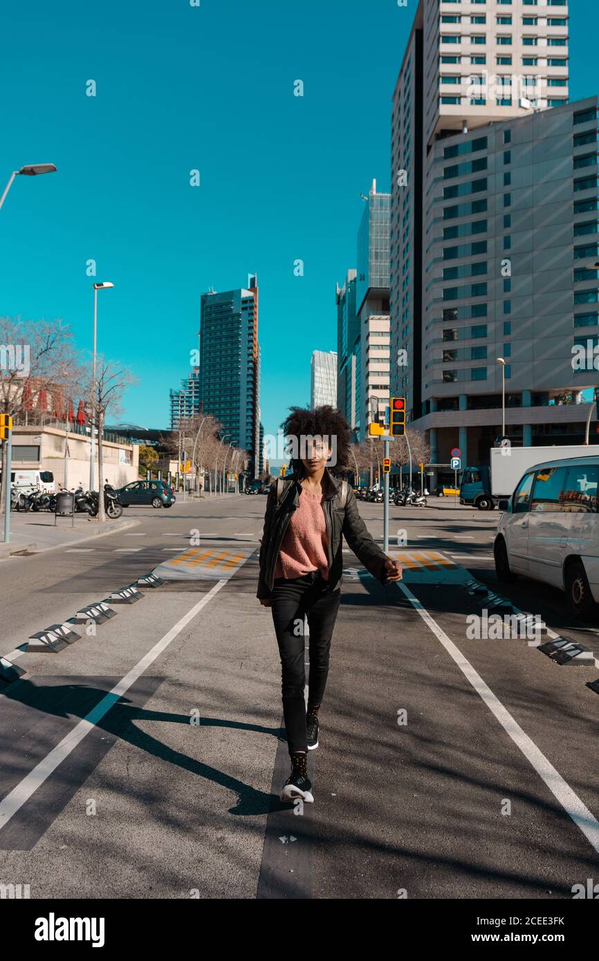 Woman with afro hair walking through the streets of a big city Stock ...