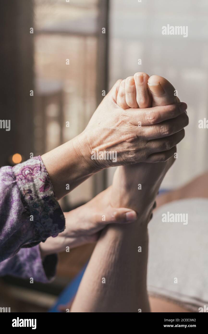 Therapist doing foot reflexology massage on patient. Treatment to balance poor circulation Stock