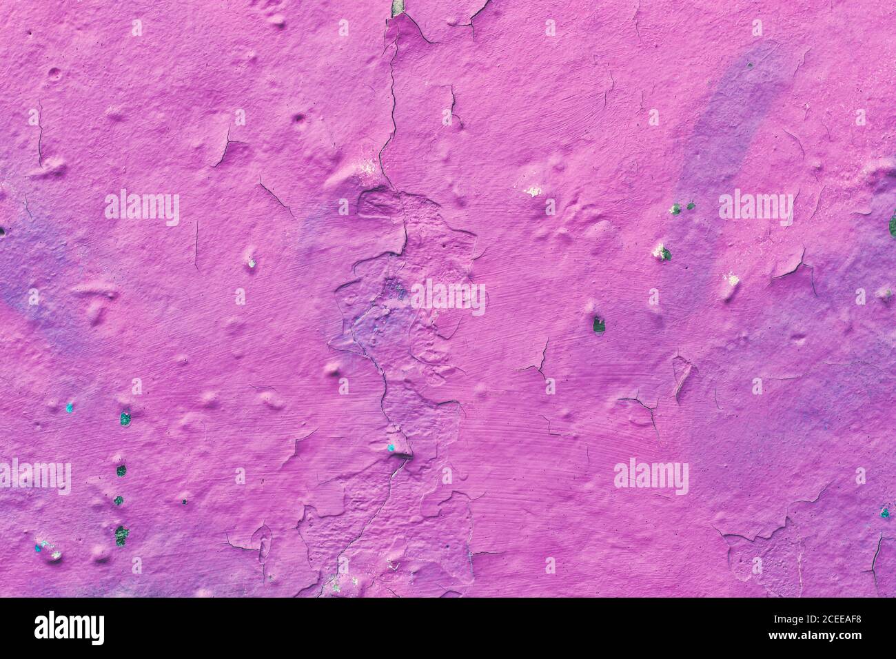 Cracked plaster, peeling pink paint on a concrete wall, scratched stucco texture, decorative design wallpaper, abstract background, natural pattern, g Stock Photo