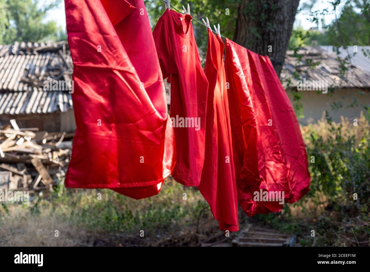 bed linen made of red silk, sheets dry outside Stock Photo Alamy