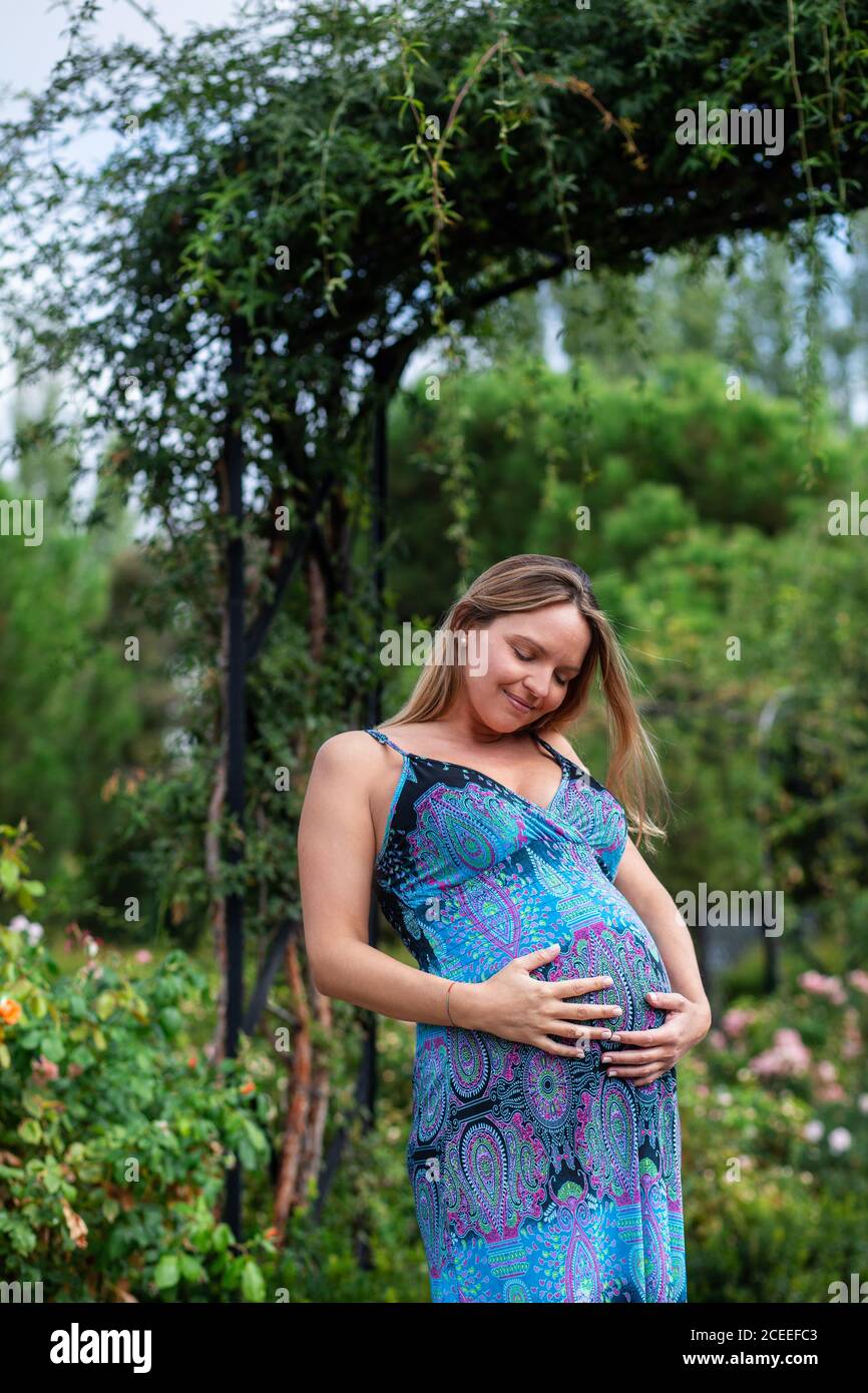 Pregnant Woman holding belly Stock Photo - Alamy