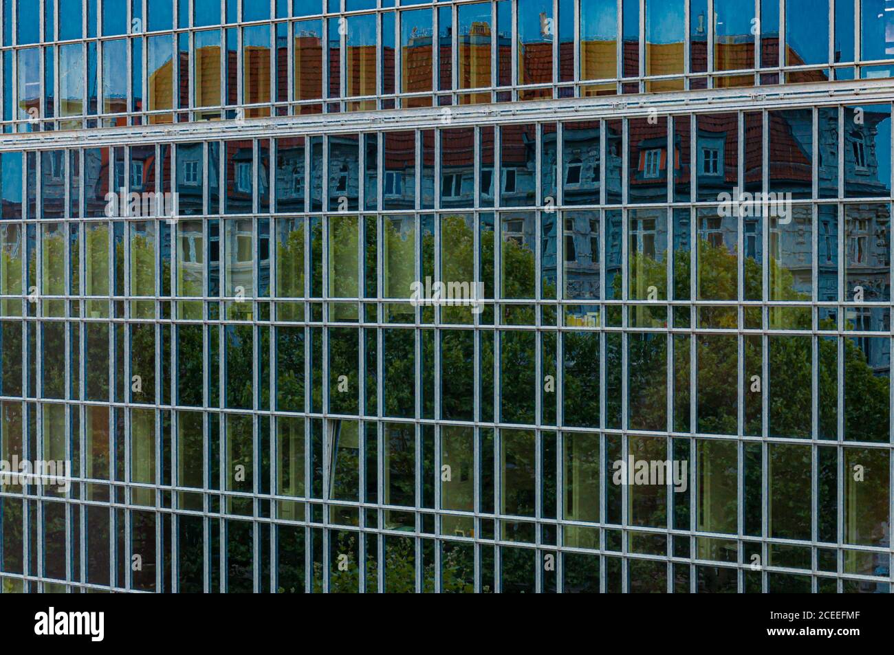 Framed glass wall of corporate building in Hamburg Germany. Distorted abstraction of city street reflection in mirrored surface of modern architecture Stock Photo