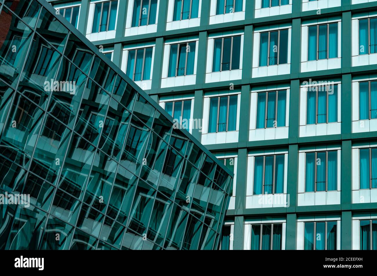 Rows of blue green glass windows. Abstract reflection in glazing wall. Urban architecture of Hamburg Germany Stock Photo