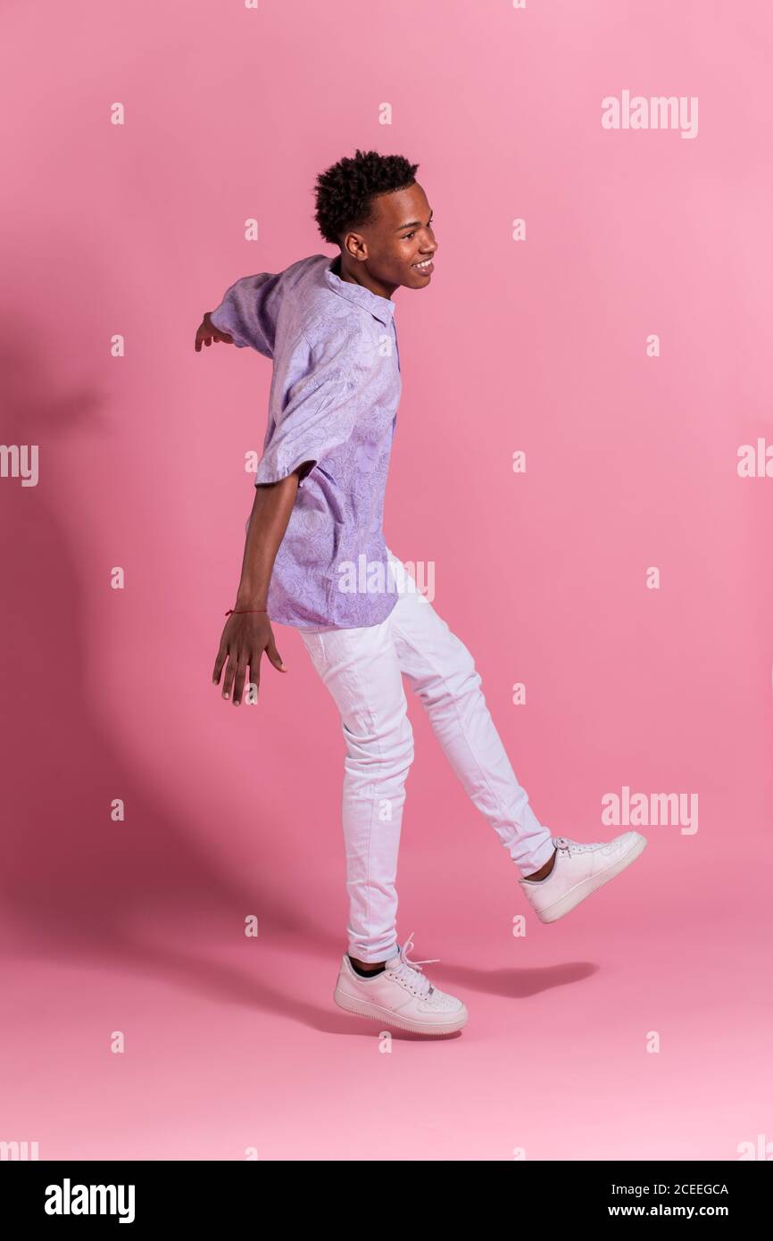 Stylish cheerful young man jumping up Stock Photo