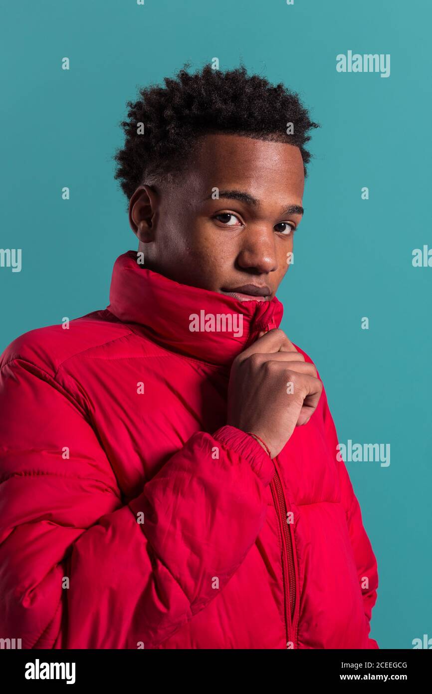 Trendy man in coat and headphones Stock Photo