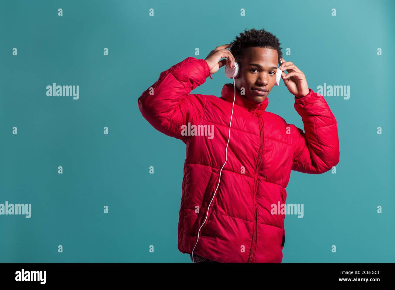 Trendy man in coat and headphones Stock Photo
