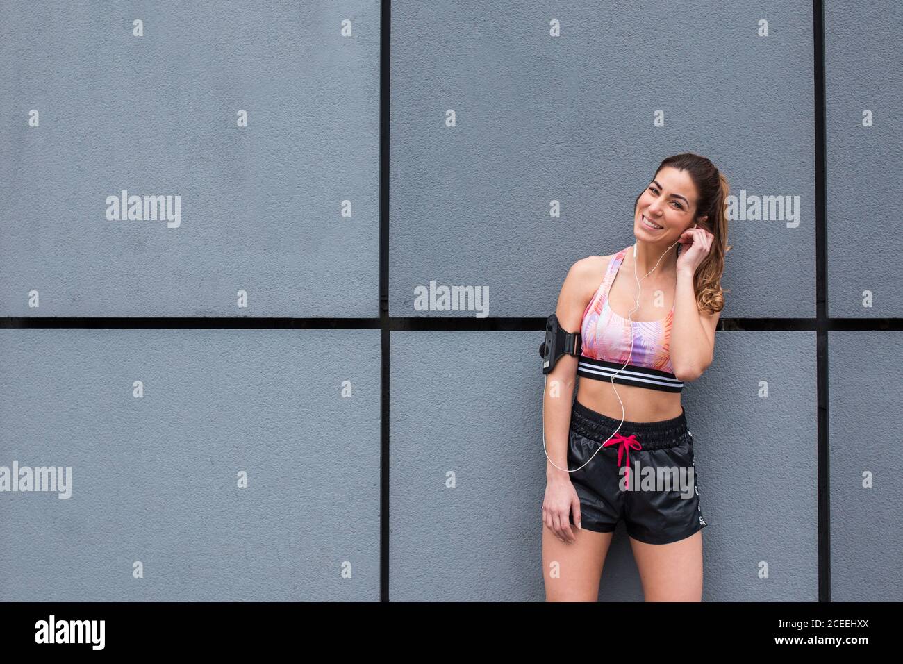 Confident sportsWoman standing on street Stock Photo
