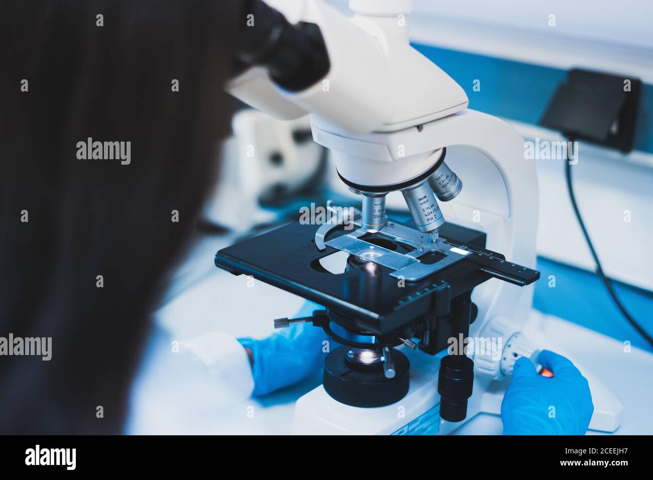 Woman using microscope hi-res stock photography and images - Alamy