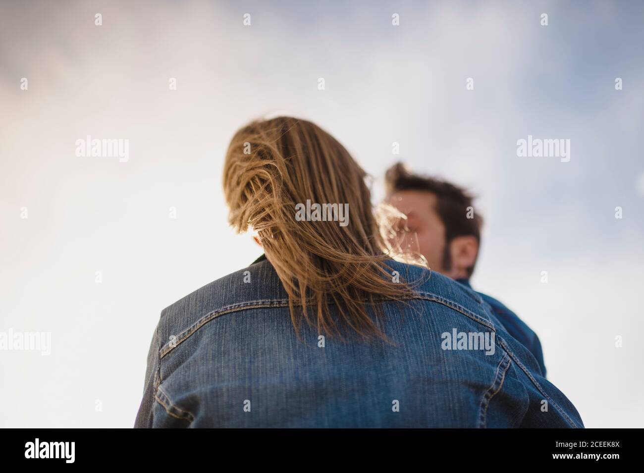 Back view of a womans hair blowing by the wind Stock Photo