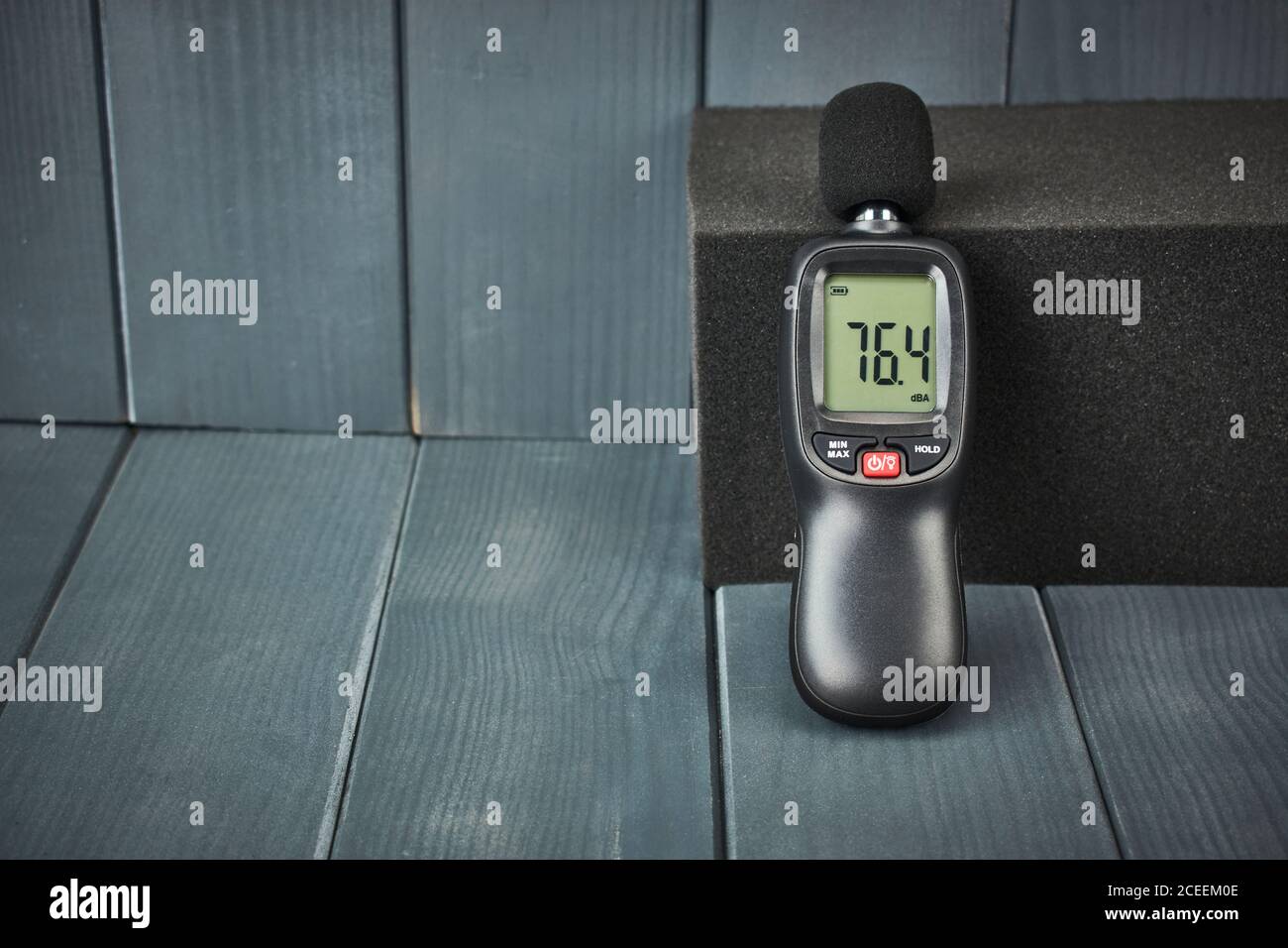 Digital sound level meter with display and control buttons on acoustic foam Stock Photo