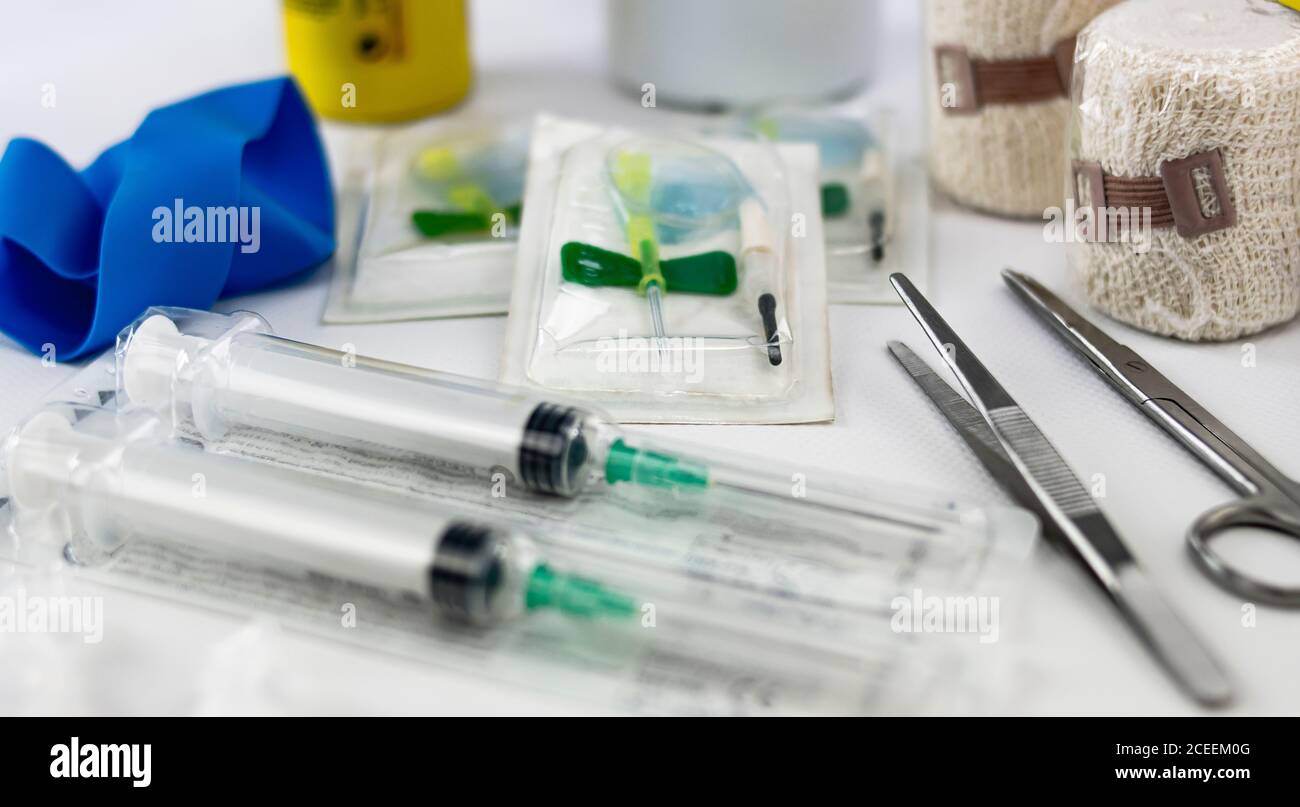 syringes, bandages, elastic pressure band, tweezers, scissors, iodine and butterfly vials to provide first medical assistance in an emergency Stock Photo