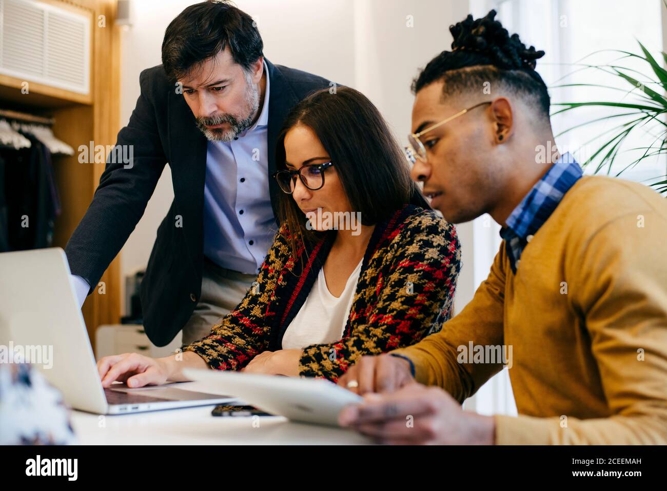People working at laptop in office Stock Photo