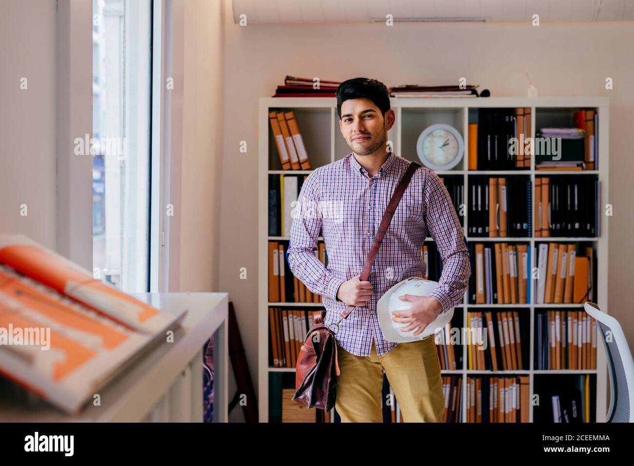 Handsome young man looking at camera in office Stock Photo