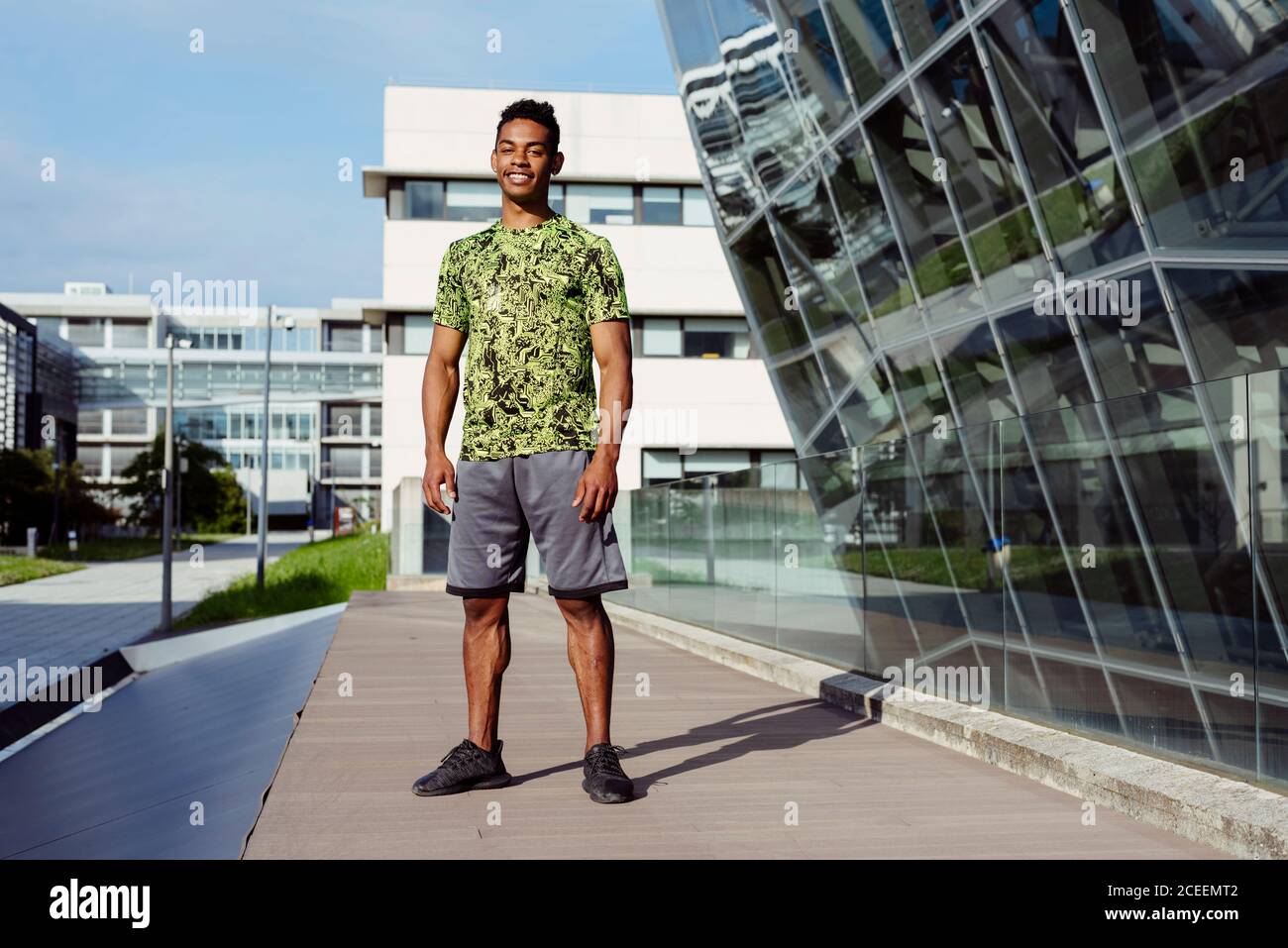 Handsome ethnic man posing in city Stock Photo