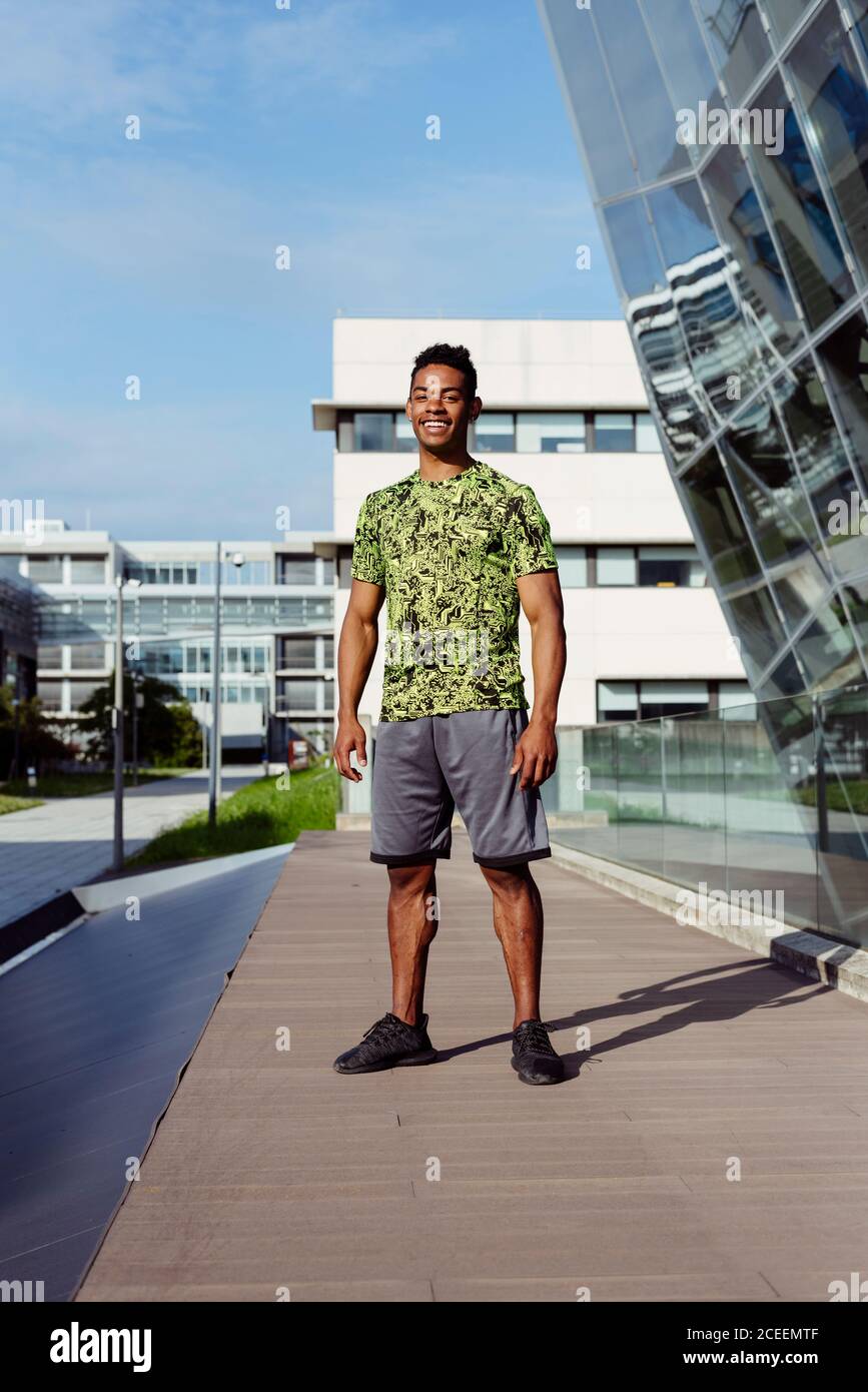 Handsome ethnic man posing in city Stock Photo