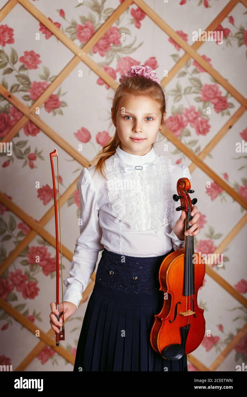 Portrait of the little violinist. Beautiful gifted little girl playing ...