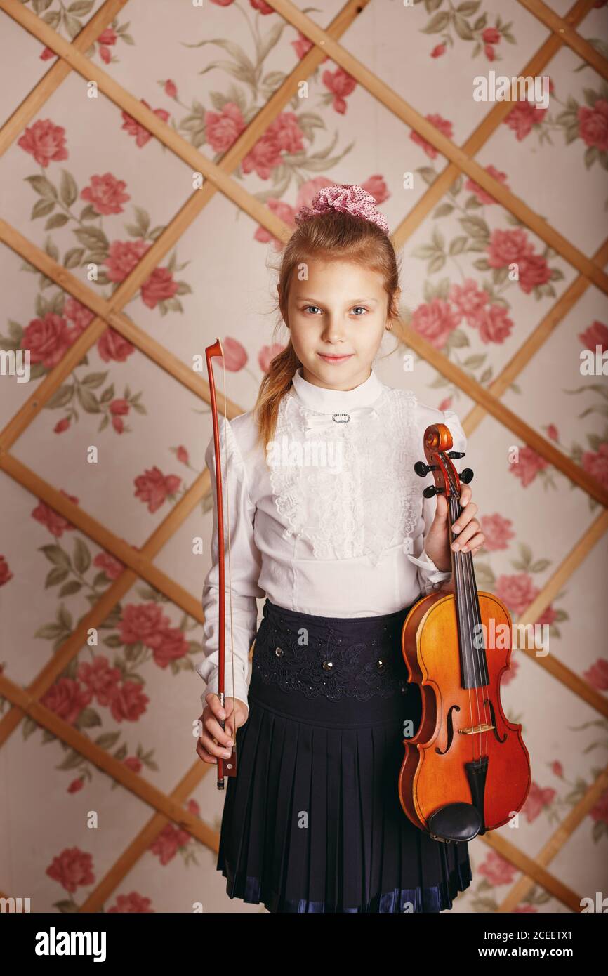 Portrait of the little violinist. Beautiful gifted little girl playing ...