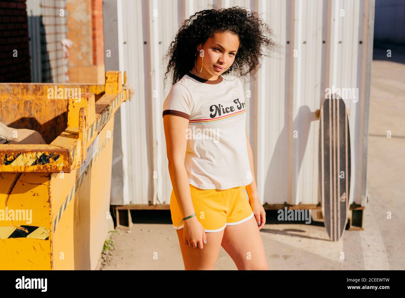 Relaxed teenager near dumpster Stock Photo