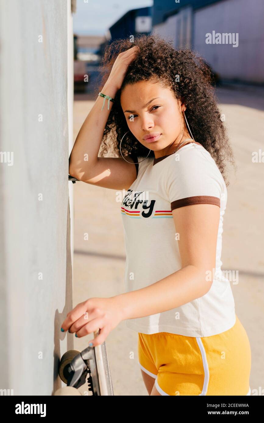 Stylish teenager with skateboard Stock Photo